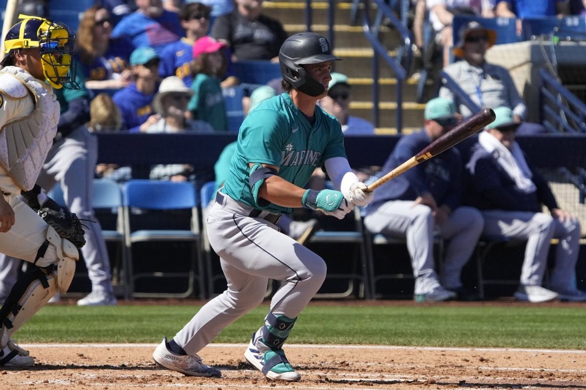 Mar 9, 2024; Phoenix, Arizona, USA; Seattle Mariners second base Cole Young (92) hits against the Milwaukee Brewers in the second inning at American Family Fields of Phoenix. Mandatory Credit: Rick Scuteri-Imagn Images