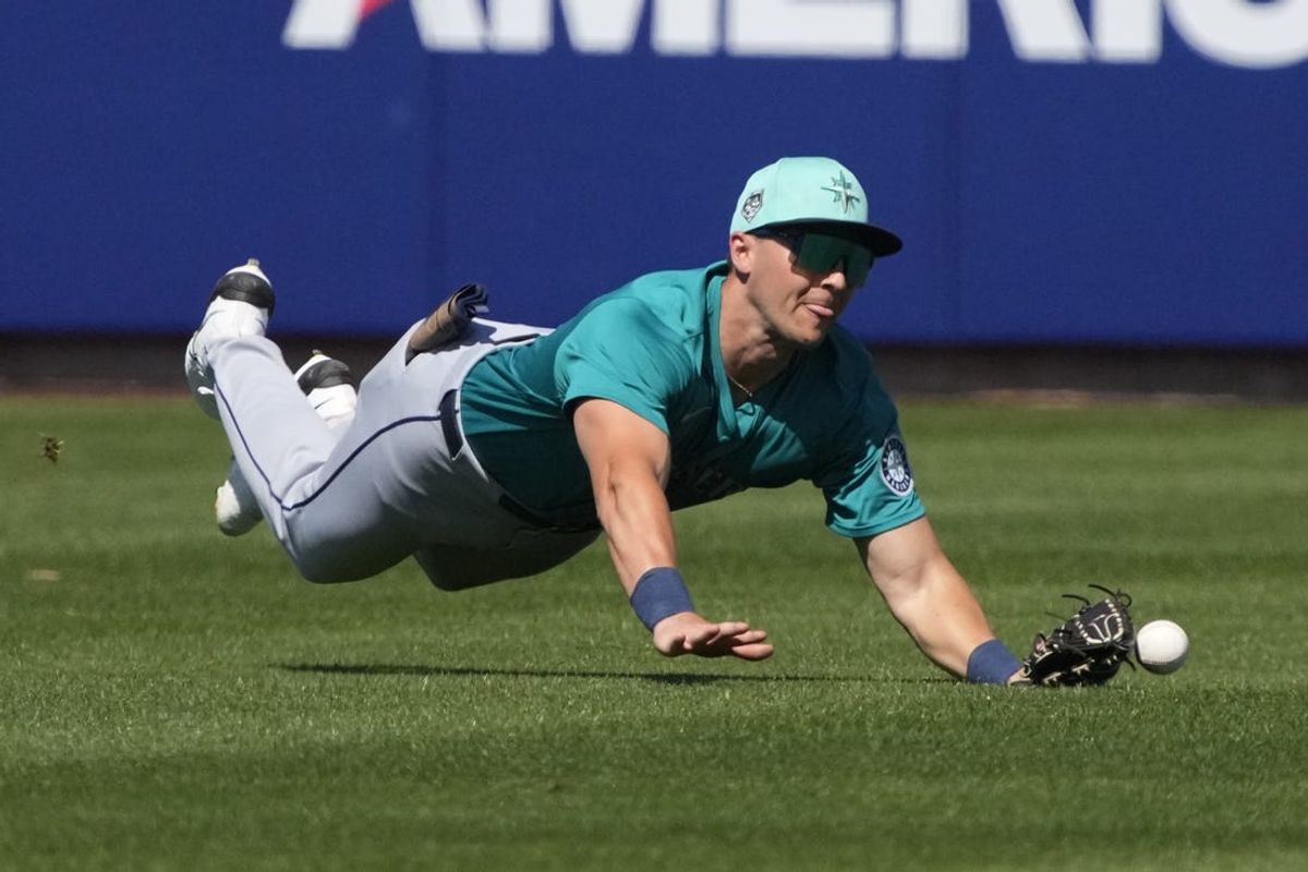 Mar 9, 2024; Phoenix, Arizona, USA; Seattle Mariners left fielder Dominic Canzone dives for the ball against the Milwaukee Brewers in the third inning at American Family Fields of Phoenix. Mandatory Credit: Rick Scuteri-USA TODAY Sports