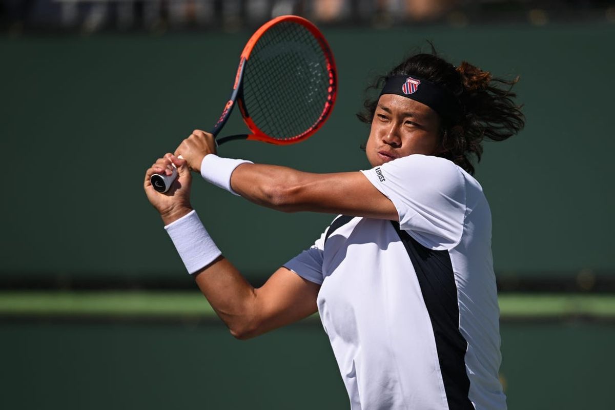 Mar 8, 2024; Indian Wells, CA, USA; Zhizhen Zhang (CHN) hits a backhand in his first round match against Aleksandar Kovacevic (USA) during the BNP Paribas Open at Indian Wells Tennis Garden. Mandatory Credit: Jonathan Hui-USA TODAY Sports