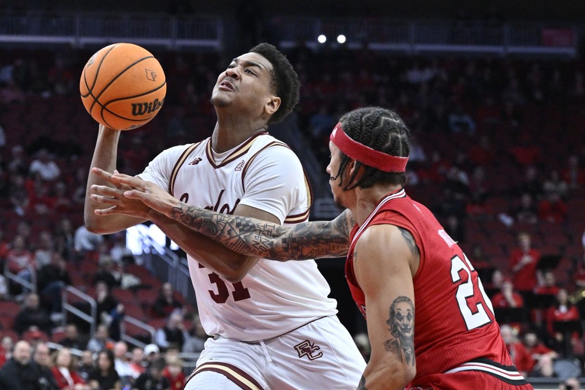 Mar 9, 2024; Louisville, Kentucky, USA;  Boston College Eagles forward Elijah Strong (31) drives to the basket against Louisville Cardinals guard Tre White (22) during the first half at KFC Yum! Center. Mandatory Credit: Jamie Rhodes-Imagn Images