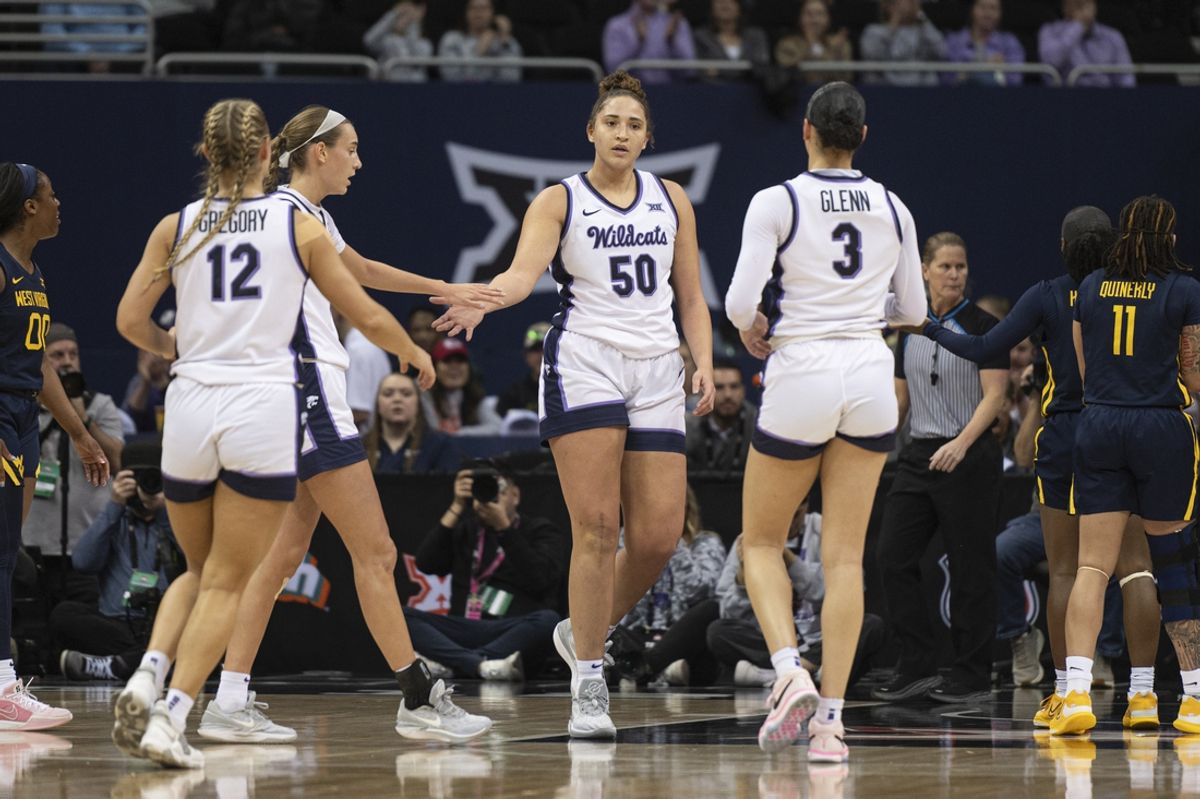 Mar 9, 2024; Kansas City, MO, USA; Teammates high five Kansas State Wildcats center Ayoka Lee (50) after making a basket against the West Virginia Mountaineers during the first half at T-Mobile Center. Mandatory Credit: Amy Kontras-Imagn Images