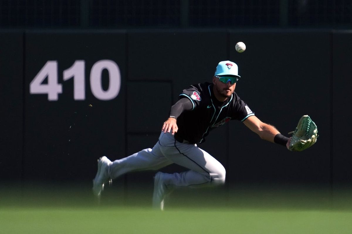 Mar 10, 2024; Phoenix, Arizona, USA; Arizona Diamondbacks center fielder Albert Almora Jr. (8) is unable to catch a fly ball against the Los Angeles Dodgers during the fourth inning at Camelback Ranch-Glendale. Mandatory Credit: Joe Camporeale-Imagn Images