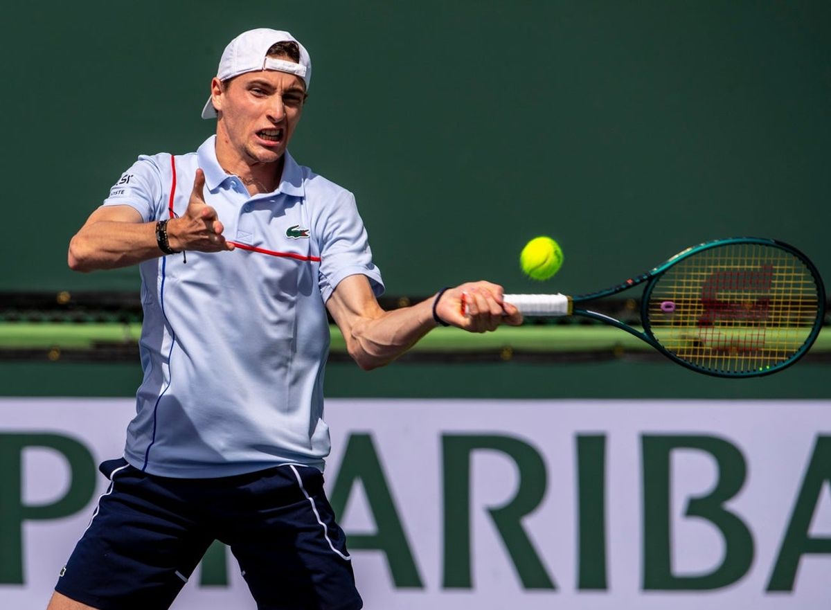 Ugo Humbert returns to Jamie Murray and Michael Venus during round one of doubles play at the BNP Paribas Open in Indian Wells, Calif., Sunday, March 10, 2024.