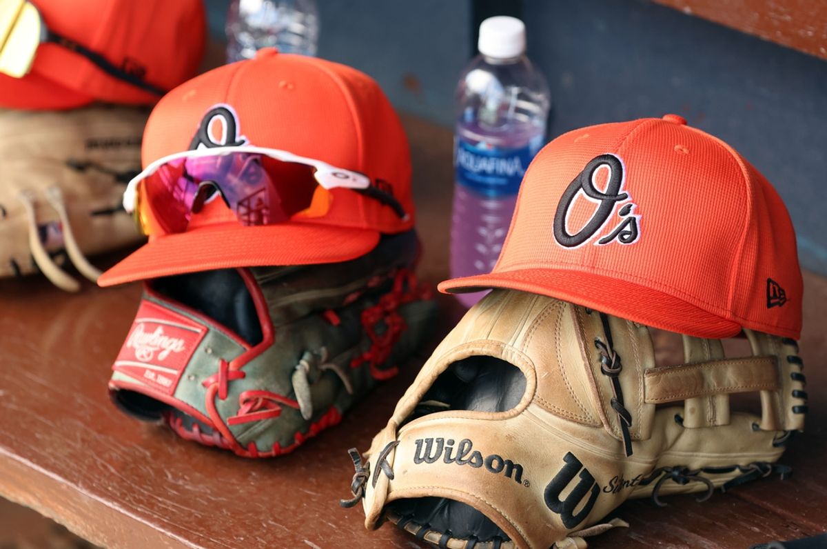 Mar 11, 2024; Tampa, Florida, USA;  A detailed view of Baltimore Orioles baseball hats and gloves in the dugout during the first inning against the New York Yankees at George M. Steinbrenner Field. Mandatory Credit: Kim Klement Neitzel-Imagn Images