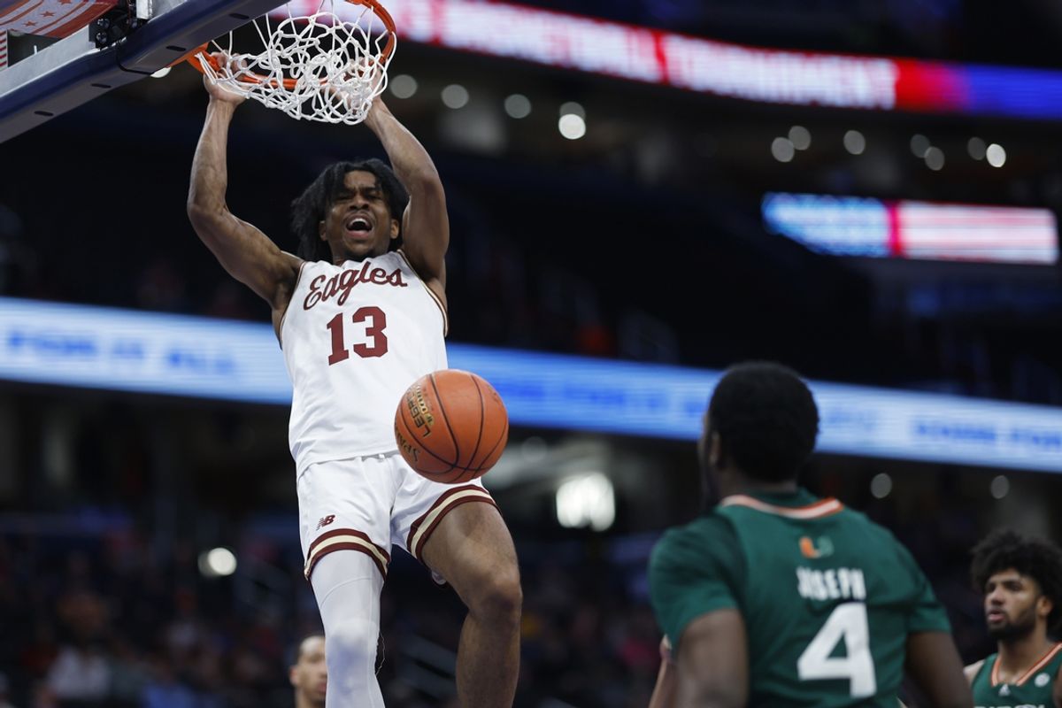 Mar 12, 2024; Washington, D.C., USA; Boston College Eagles guard Donald Hand Jr. (13) dunks the ball as Miami (Fl) Hurricanes guard Bensley Joseph (4) looks on in the second half at Capital One Arena. Mandatory Credit: Geoff Burke-Imagn Images