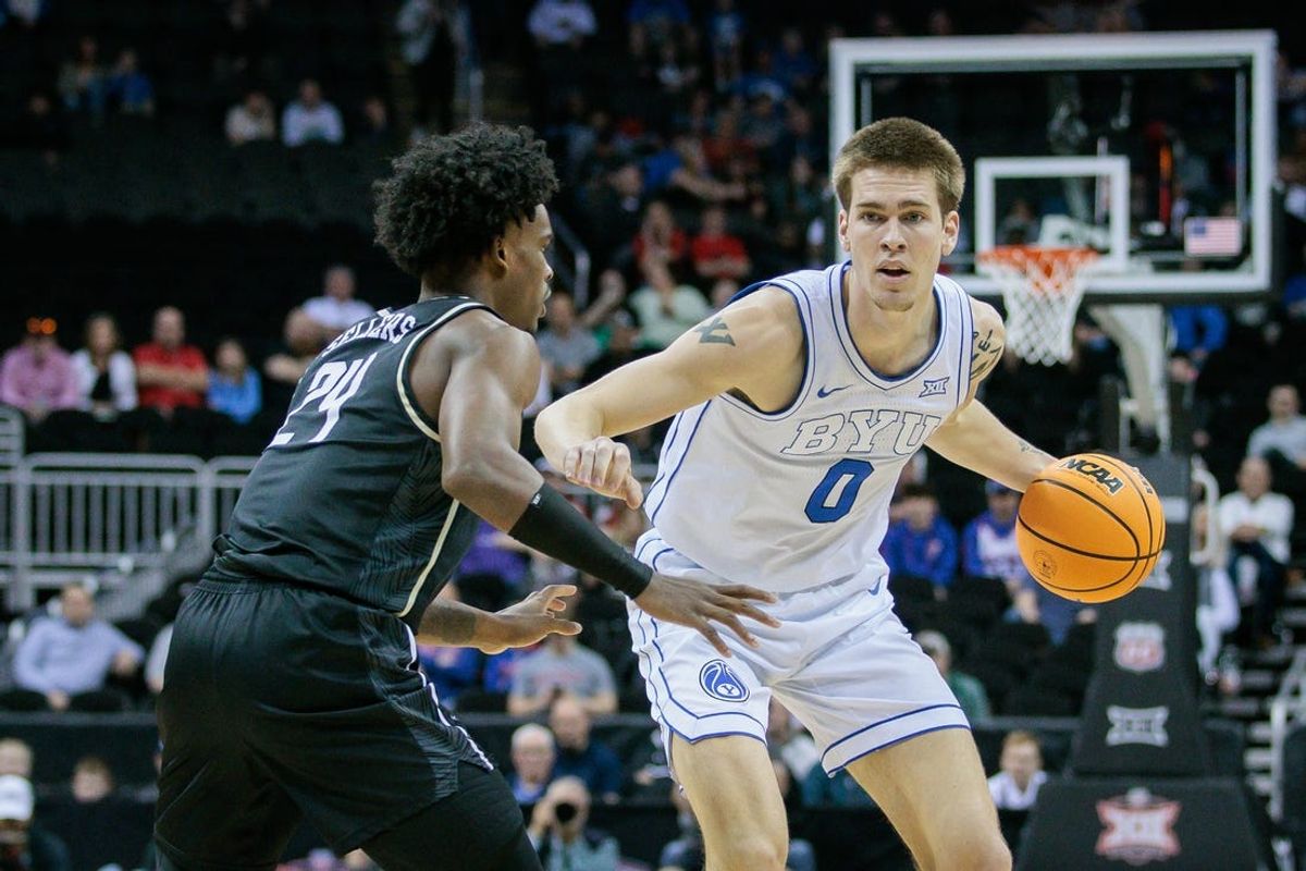 Mar 13, 2024; Kansas City, MO, USA; Brigham Young Cougars forward Noah Waterman (0) brings the ball up court around UCF Knights guard Jaylin Sellers (24) during the first half at T-Mobile Center. Mandatory Credit: William Purnell-USA TODAY Sports