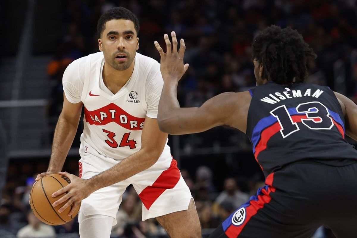 Mar 13, 2024; Detroit, Michigan, USA;  Toronto Raptors center Jontay Porter (34) is defended by Detroit Pistons center James Wiseman (13) in the second half at Little Caesars Arena. Mandatory Credit: Rick Osentoski-Imagn Images