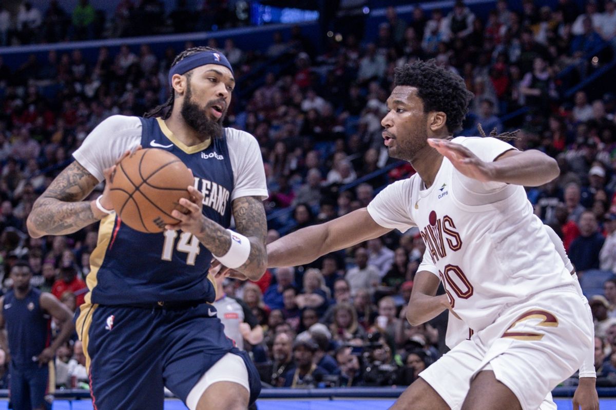 Mar 13, 2024; New Orleans, Louisiana, USA; New Orleans Pelicans forward Brandon Ingram (14) dribbles against Cleveland Cavaliers center Damian Jones (30) during the second half at Smoothie King Center. Mandatory Credit: Stephen Lew-Imagn Images