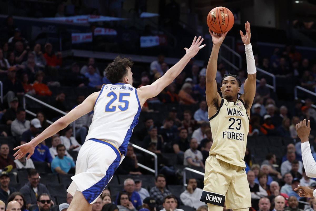 Mar 14, 2024; Washington, D.C., USA; Wake Forest Demon Deacons guard Hunter Sallis (23) shoots the ball as Pittsburgh Panthers forward Guillermo Diaz Graham (25) defends in the second half at Capital One Arena. Mandatory Credit: Geoff Burke-Imagn Images