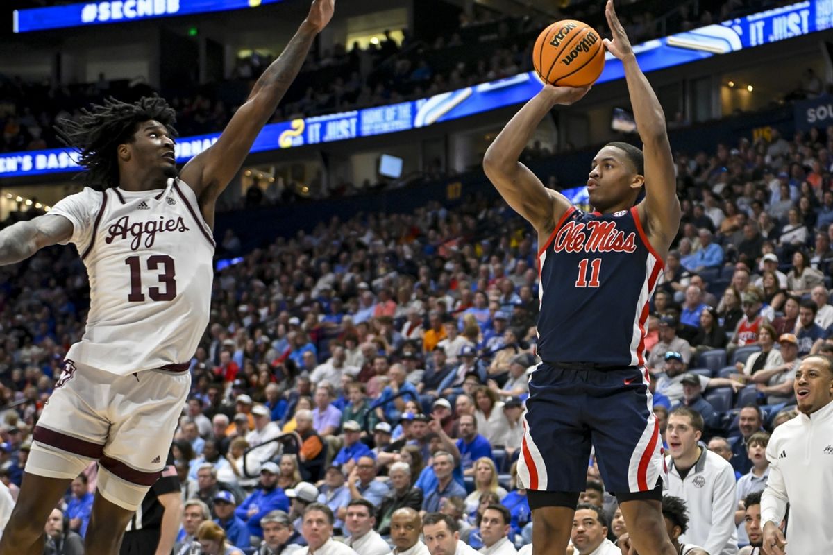 Mar 14, 2024; Nashville, TN, USA;  Mississippi Rebels guard Matthew Murrell (11) shoots over Texas A&M Aggies forward Solomon Washington (13) during the first half at Bridgestone Arena. Mandatory Credit: Steve Roberts-Imagn Images