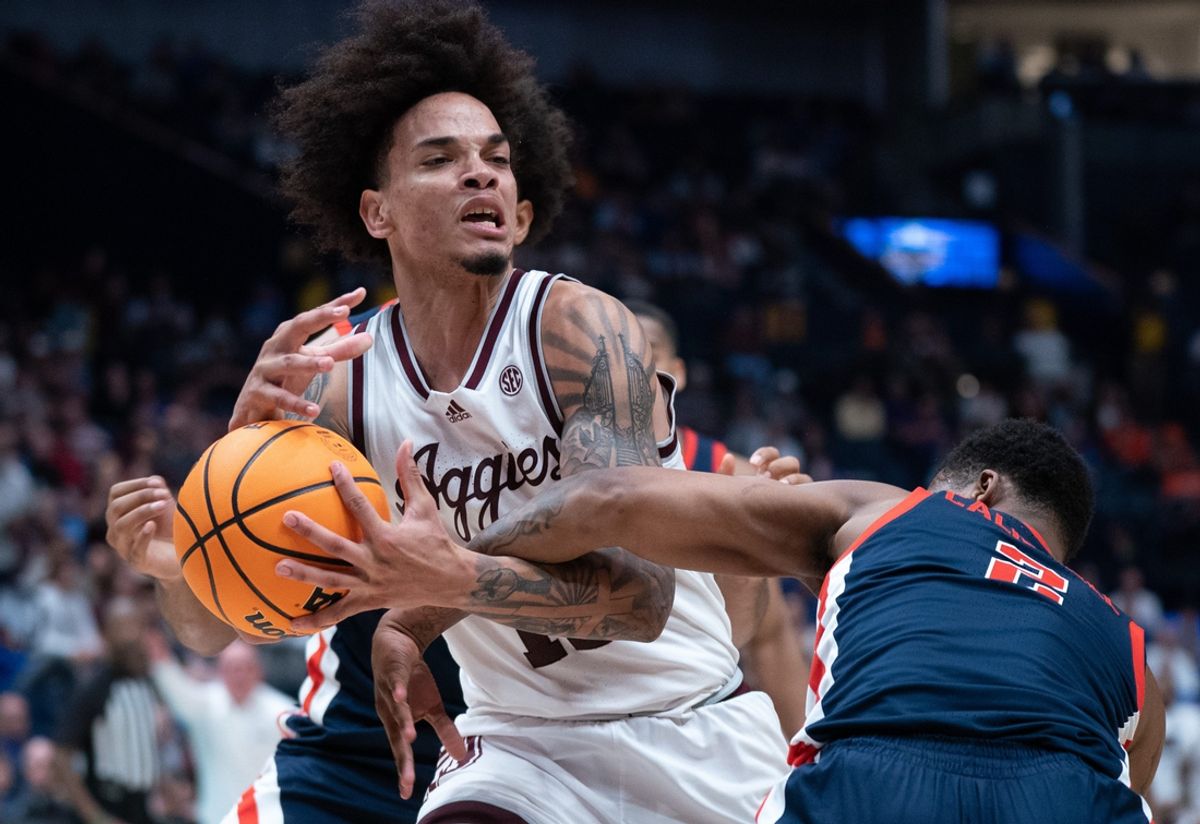Texas A&M Aggies forward Andersson Garcia (11) is fouled by Mississippi Rebels guard TJ Caldwell (2) late in their second round game of the SEC Men's Basketball Tournament at Bridgestone Arena in Nashville, Tenn., Thursday, March 14, 2024.