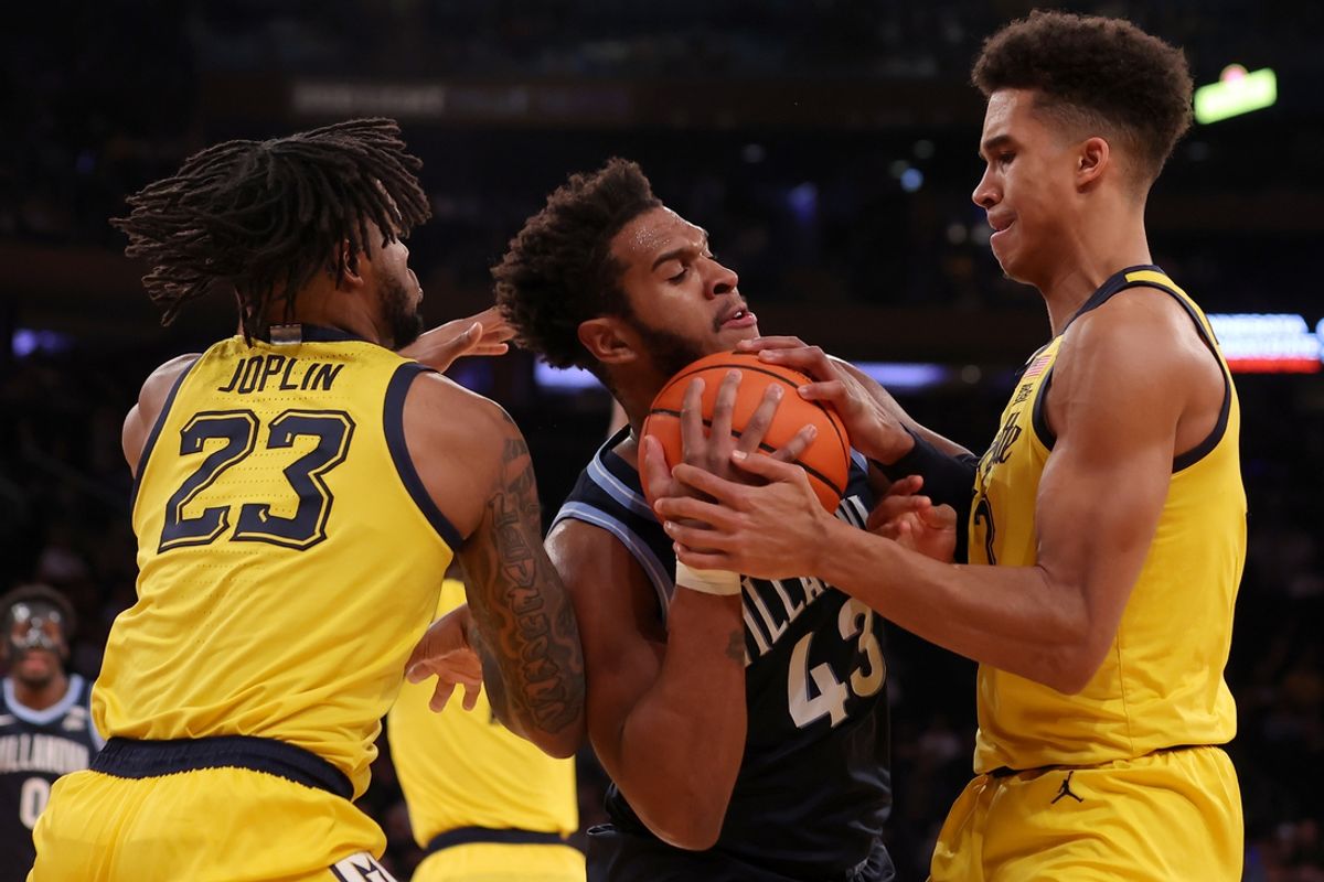 Mar 14, 2024; New York City, NY, USA; Villanova Wildcats forward Eric Dixon (43) fights for the ball against Marquette Golden Eagles forwards David Joplin (23) and Oso Ighodaro (13) during the first half at Madison Square Garden. Mandatory Credit: Brad Penner-Imagn Images