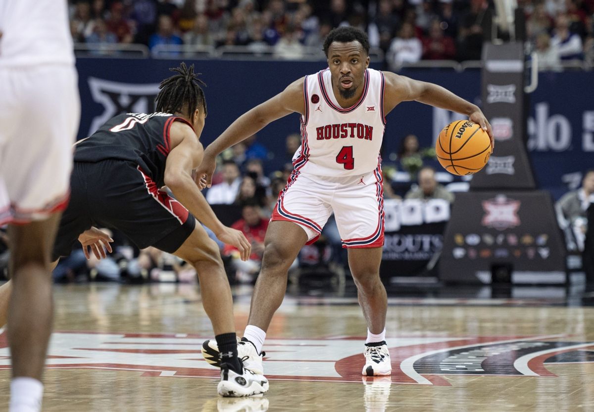 Mar 15, 2024; Kansas City, MO, USA; Houston Cougars guard LJ Cryer (4) controls the ball while defended by Texas Tech Red Raiders guard Chance McMillian (0)  in the second half at T-Mobile Center. Mandatory Credit: Amy Kontras-Imagn Images