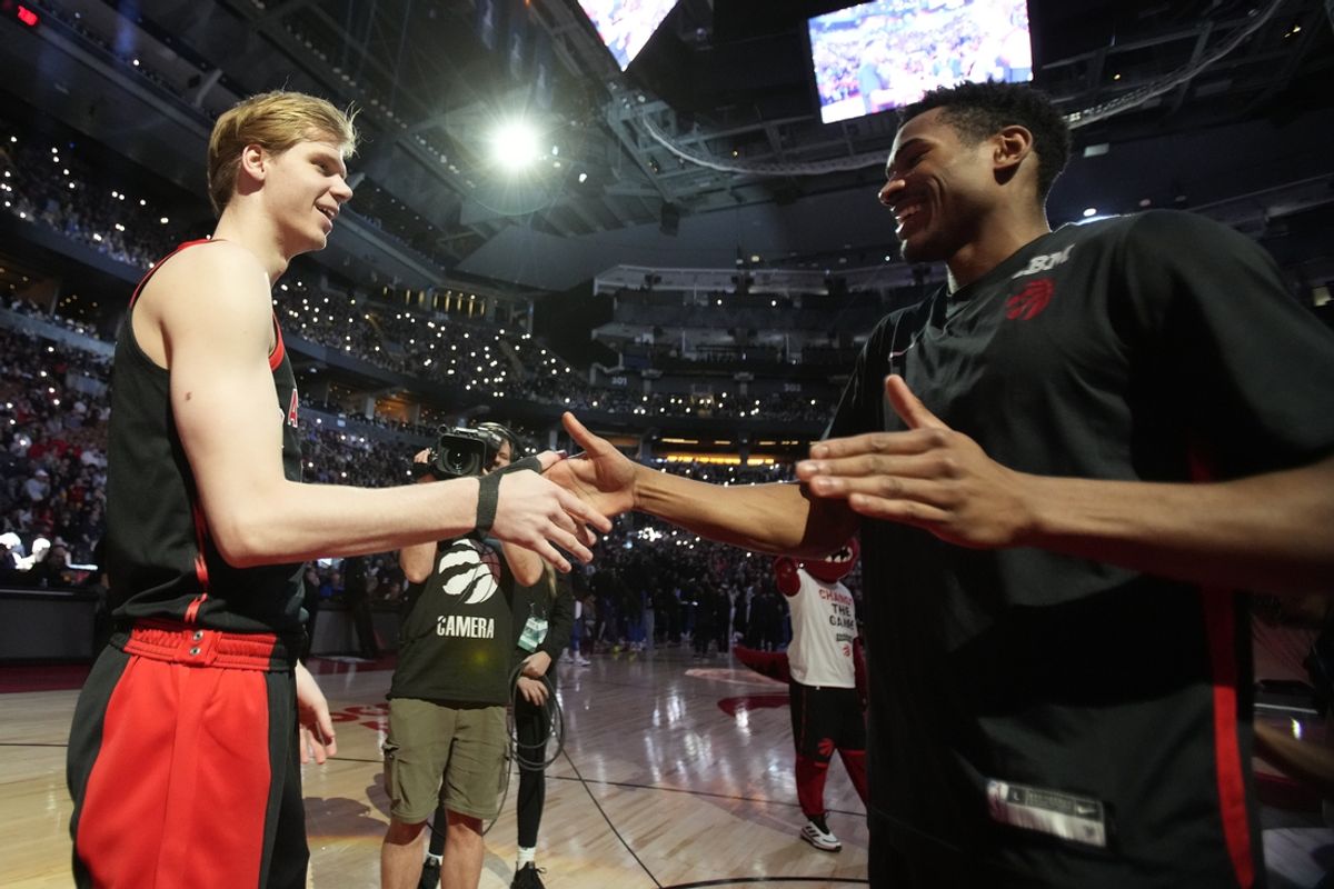 Mar 15, 2024; Toronto, Ontario, CAN; Toronto Raptors guard Gradey Dick (left) and guard Ochai Agbaji (right) during player introductions before a game against the Orlando Magic at Scotiabank Arena. Mandatory Credit: John E. Sokolowski-Imagn Images