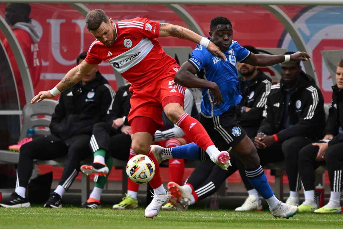 Mar 16, 2024; Chicago, Illinois, USA; Chicago Fire FC defender Rafael Czichos (5) and CF Montreal forward Sunusi Ibrahim (14) battle for a ball during the first half at Soldier Field. Mandatory Credit: Jamie Sabau-Imagn Images