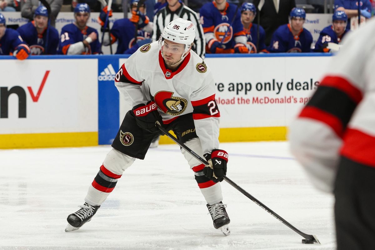 Mar 16, 2024; Elmont, New York, USA;  Ottawa Senators defenseman Erik Brannstrom (26) moves the puck against the New York Islanders during the third period at UBS Arena. Mandatory Credit: Thomas Salus-Imagn Images
