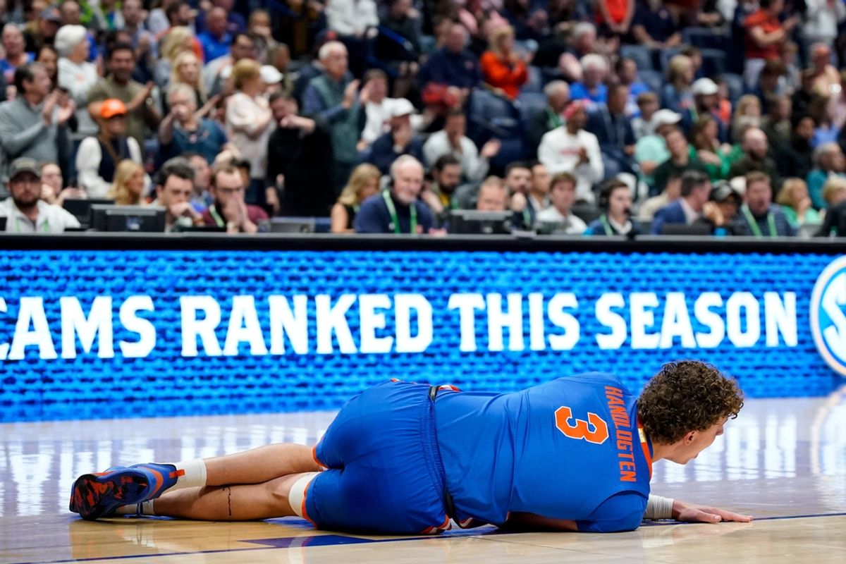 Florida center Micah Handlogten (3) falls with an injury during the first half of the SEC tournament championship game against Auburn at Bridgestone Arena in Nashville, Tenn., Sunday, March 17, 2024.