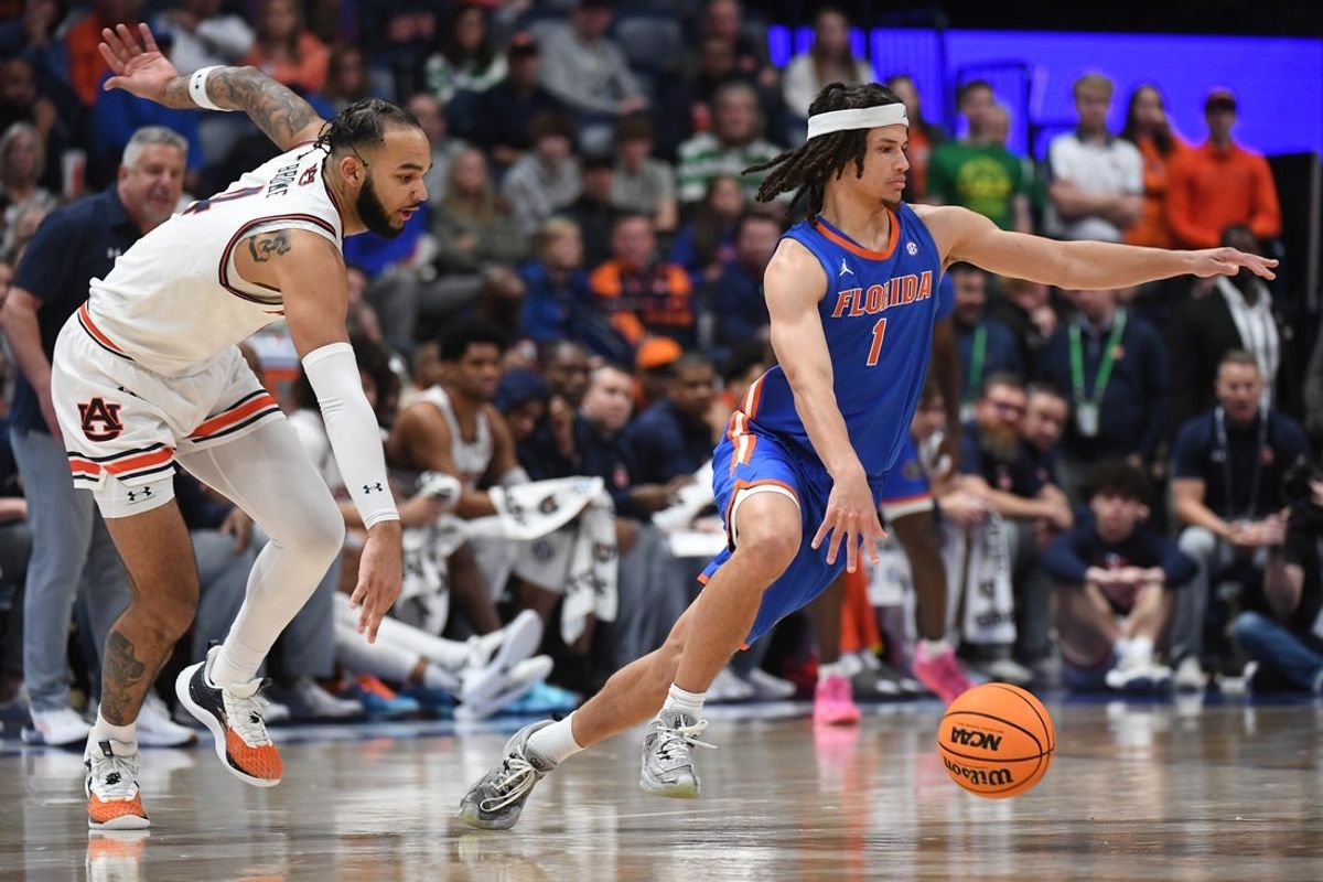 Florida Gators guard Walter Clayton Jr. (1) controls the ball against Auburn Tigers forward Johni Broome (4) in the first half in the SEC Tournament championship game at Bridgestone Arena. Mandatory Credit: Christopher Hanewinckel-Imagn Images