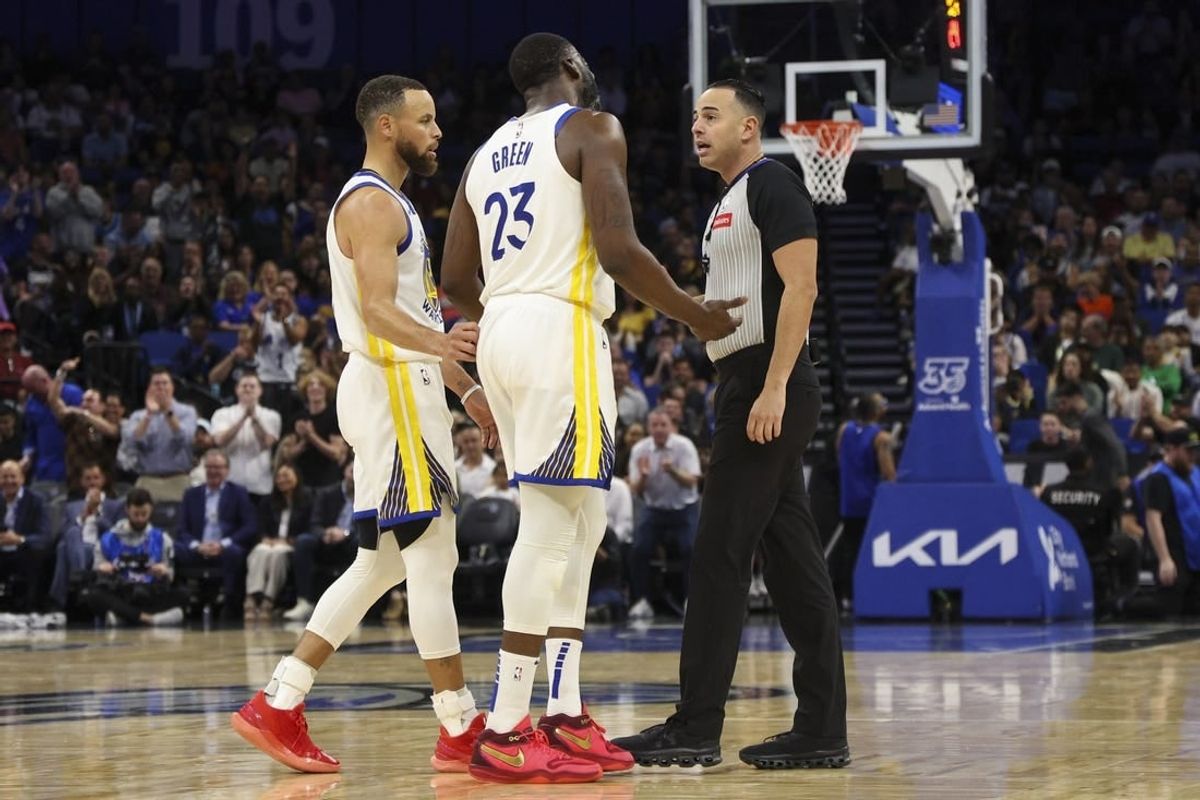 Mar 27, 2024; Orlando, Florida, USA;  Golden State Warriors forward Draymond Green (23) talks to referee Ray Acosta (54) after receiving a foul in the first quarter at the Kia Center.