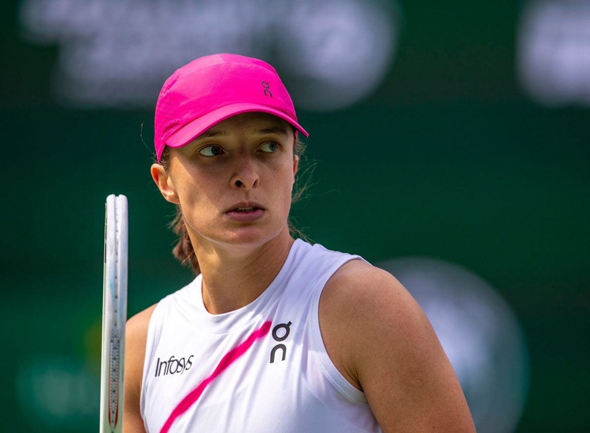 Iga Swiatek looks to her coaches box after winning a point against Maria Sakkari during the WTA final of the BNP Paribas Open in Indian Wells, Calif., Sunday, March 17, 2024.