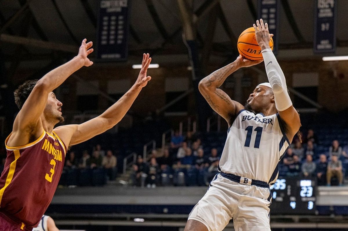 Butler Bulldogs guard Jahmyl Telfort (11) shoots over the defense of Minnesota Golden Gophers forward Dawson Garcia (3) during the first half of an NCAA/NIT game, Tuesday, March 19, 2024, at Hinkle Fieldhouse on the campus of Butler University in Indianapolis.