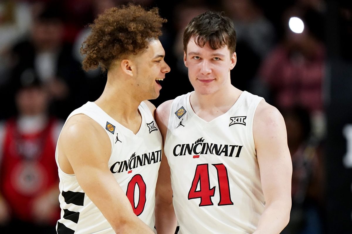 Cincinnati Bearcats guard Dan Skillings Jr. (0) congratulates Cincinnati Bearcats guard Simas Lukosius (41) on a made 3-point basket in the second half of a college basketball game in the National Invitation Tournament, Wednesday, March 20, 2024, at Fifth Third Arena in Cincinnati.