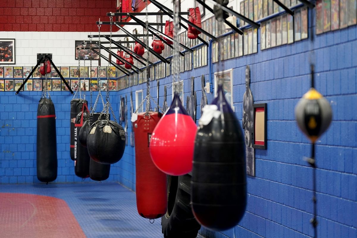 Photos and boxing equipment lines the walls of the Cincinnati Golden Gloves for Youth, Monday, March 18, 2024, at Golden Gloves boxing gym in the Over-the-Rhine Recreation Center in Cincinnati. The Cincinnati Golden Gloves for Youth is aiming to move from its Over-the-Rhine home at 1715 Republic St. to the former Elmwood Place Elementary School at 400 Maple St.