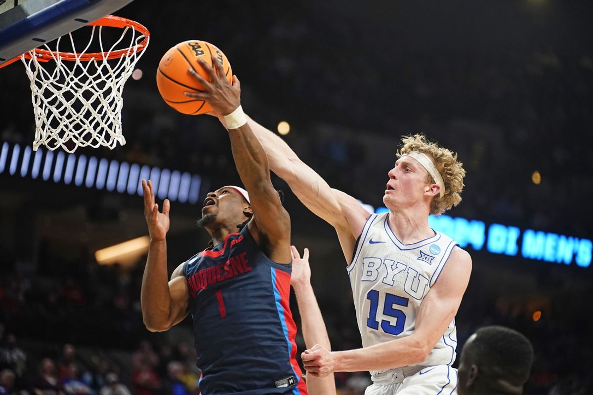 Mar 21, 2024; Omaha, NE, USA; Duquesne Dukes guard Jimmy Clark III (1) drives against Brigham Young Cougars guard Richie Saunders (15) during the second half in the first round of the 2024 NCAA Tournament at CHI Health Center Omaha. Mandatory Credit: Dylan Widger-Imagn Images