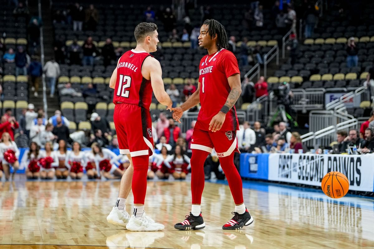 Mar 21, 2024; Pittsburgh, PA, USA; North Carolina State Wolfpack guard Jayden Taylor (1) and North Carolina State Wolfpack guard Michael O'Connell (12) celebrate their win against the Texas Tech Red Raiders in the first round of the 2024 NCAA Tournament at PPG Paints Arena. Mandatory Credit: Gregory Fisher-Imagn Images