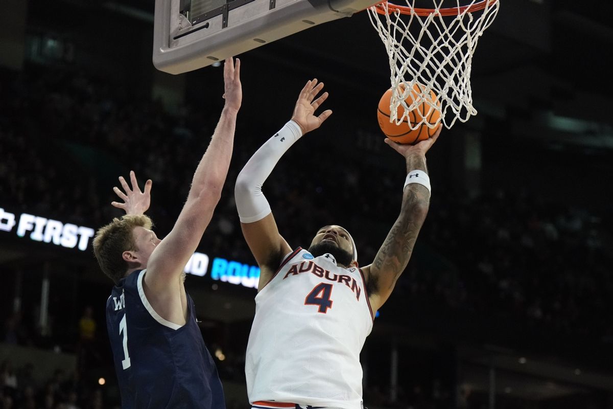 Mar 22, 2024; Spokane, WA, USA; Auburn Tigers forward Johni Broome (4) attempts a layup against Yale Bulldogs forward Danny Wolf (1) during the first half of a game in the first round of the 2024 NCAA Tournament at Spokane Veterans Memorial Arena. Mandatory Credit: Kirby Lee-Imagn Images