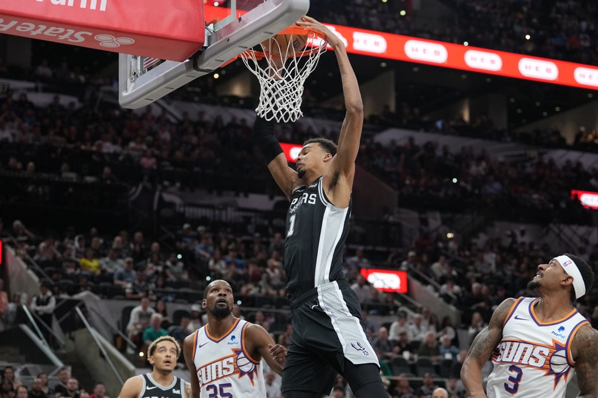 Mar 23, 2024; San Antonio, Texas, USA;  San Antonio Spurs center Victor Wembanyama (1) dunks the ball in front of Phoenix Suns forward Kevin Durant (35) and guard Bradley Beal (3) in the first half at Frost Bank Center. Mandatory Credit: Daniel Dunn-Imagn Images