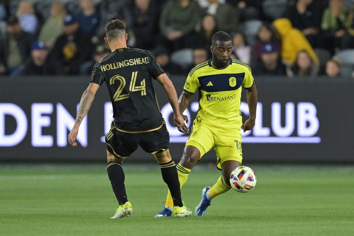 Mar 23, 2024; Los Angeles, California, USA; Nashville SC defender Shaq Moore (18) dribbles the ball against LAFC defender Ryan Hollingshead (24) during the first half at BMO Stadium. Mandatory Credit: Jayne Kamin-Oncea-USA TODAY Sports
