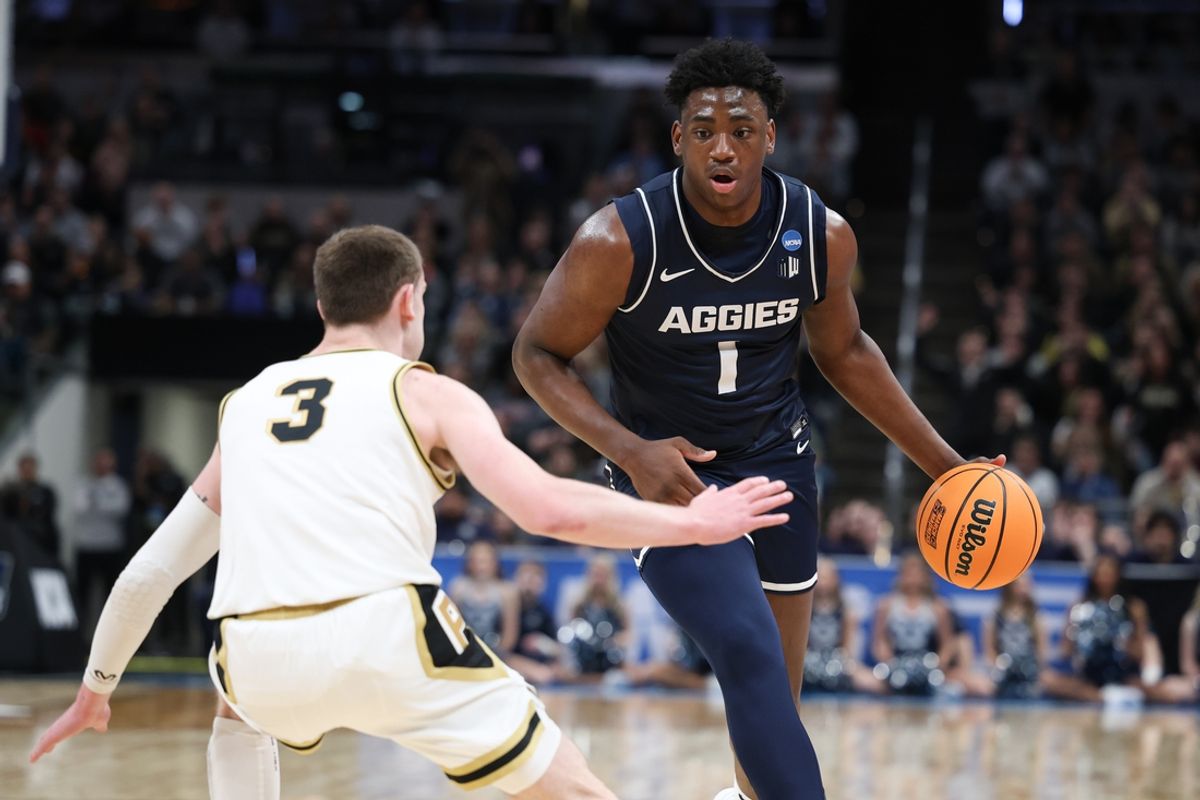 Mar 24, 2024; Indianapolis, IN, USA; Utah State Aggies forward Great Osobor (1) dribbles against Purdue Boilermakers guard Braden Smith (3) during the first half at Gainbridge FieldHouse. Mandatory Credit: Trevor Ruszkowski-Imagn Images