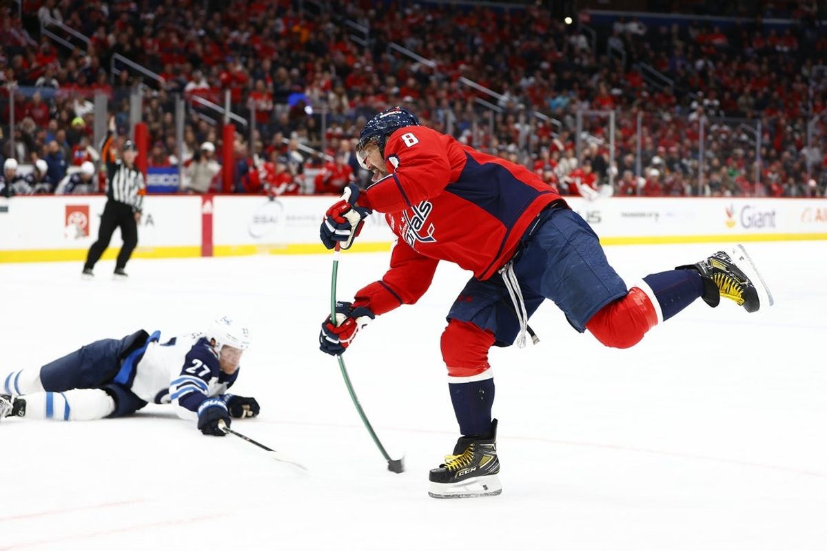 Mar 24, 2024; Washington, District of Columbia, USA; Washington Capitals left wing Alex Ovechkin (8) shoots the puck past Winnipeg Jets left wing Nikolaj Ehlers (27) during the third period at Capital One Arena. Mandatory Credit: Amber Searls-Imagn Images