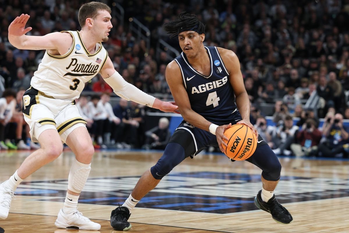 Mar 24, 2024; Indianapolis, IN, USA; Utah State Aggies guard Ian Martinez (4) evades Purdue Boilermakers guard Braden Smith (3) during the first half at Gainbridge FieldHouse. Mandatory Credit: Trevor Ruszkowski-Imagn Images
