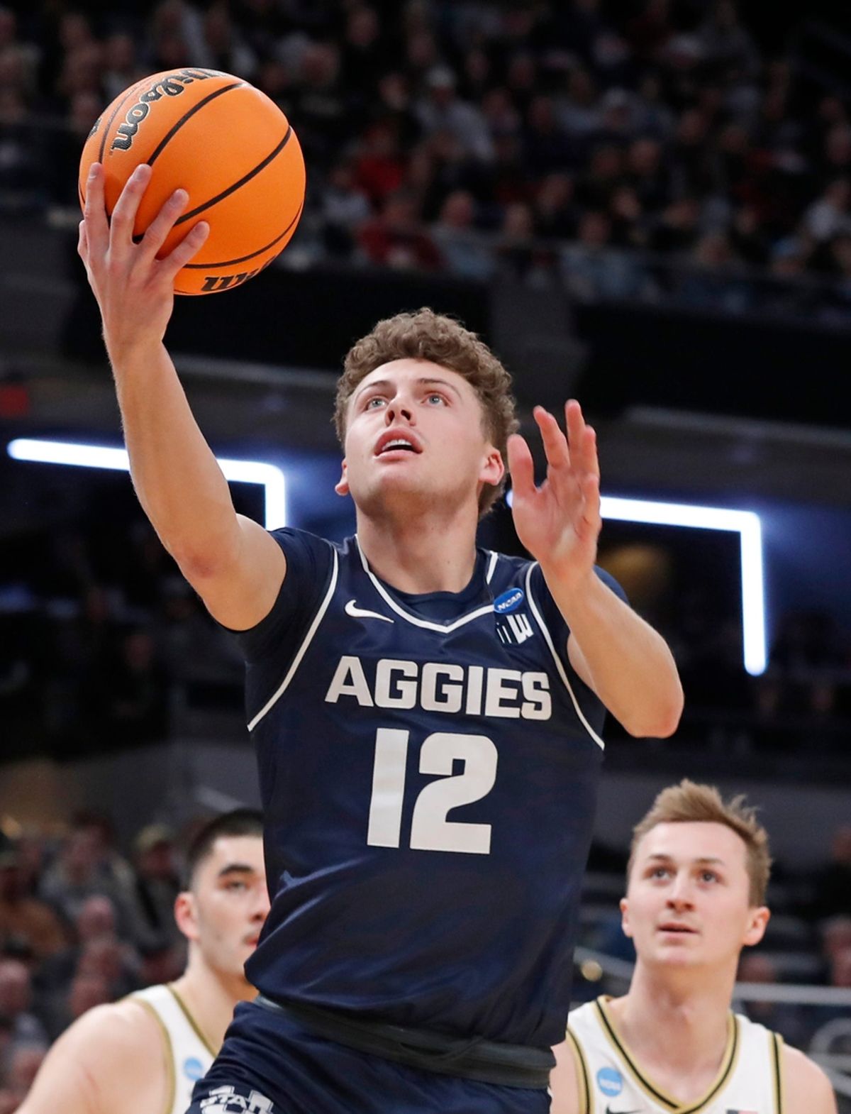 Utah State Aggies guard Mason Falslev (12) shoots the ball during NCAA Men’s Basketball Tournament game against the Purdue Boilermakers, Sunday, March 24, 2024, at Gainbridge Fieldhouse in Indianapolis.