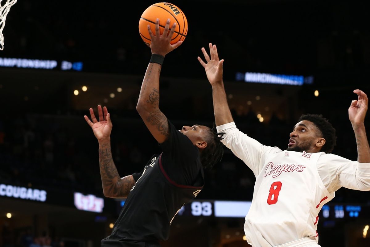 Mar 24, 2024; Memphis, TN, USA; Texas A&M Aggies guard Wade Taylor IV (4) shoots against Houston Cougars guard Mylik Wilson (8) in overtime in the second round of the 2024 NCAA Tournament at FedExForum. Mandatory Credit: Petre Thomas-Imagn Images