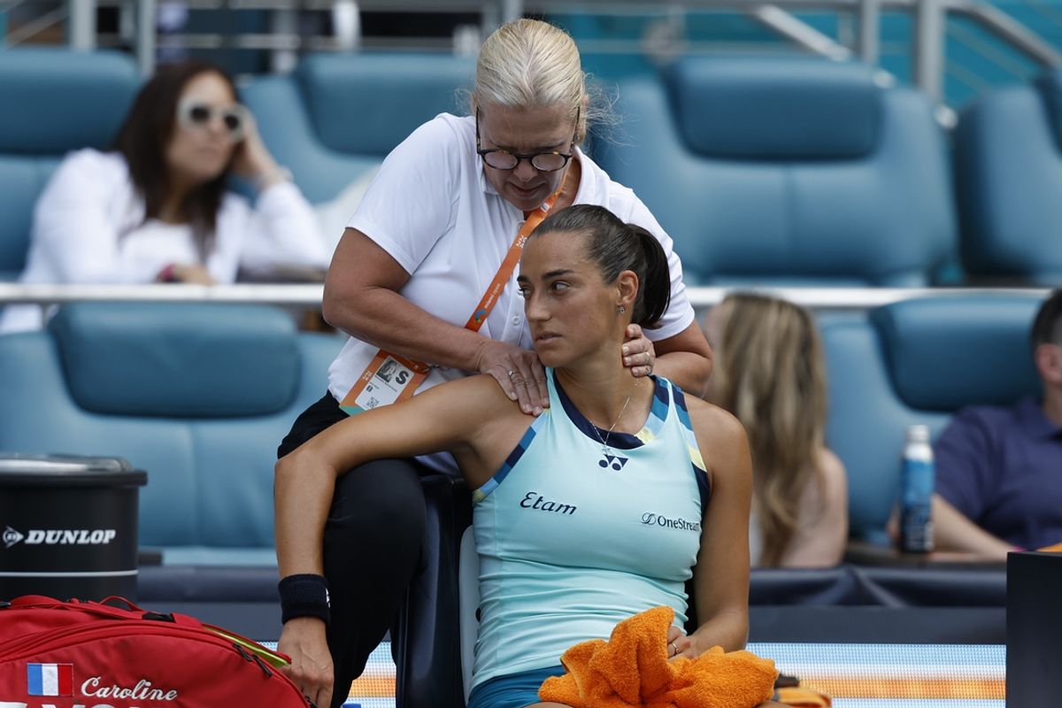 Mar 25, 2024; Miami Gardens, FL, USA; Caroline Garcia (FRA) receives treatment from a WTA trainer during a changeover against Coco Gauff (USA) (not pictured) on day eight of the Miami Open at Hard Rock Stadium. Mandatory Credit: Geoff Burke-Imagn Images