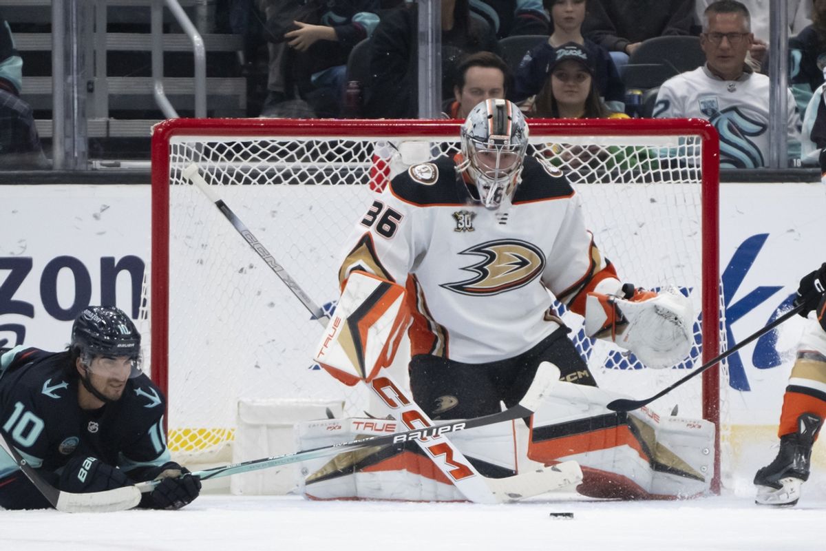 Mar 26, 2024; Seattle, Washington, USA; The puck sits in front of Anaheim Ducksgoalie John Gibson (36) and. Seattle Kraken forward Matty Beniers (10) during the first period at Climate Pledge Arena. Mandatory Credit: Stephen Brashear-Imagn Images