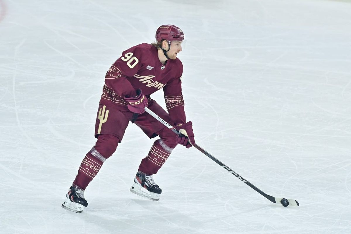 Mar 28, 2024; Tempe, Arizona, USA; Arizona Coyotes defenseman J.J. Moser (90) carries the puck in the first period against the Nashville Predators at Mullett Arena. Mandatory Credit: Matt Kartozian-USA TODAY Sports