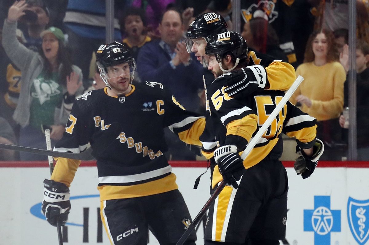 Mar 28, 2024; Pittsburgh, Pennsylvania, USA;  Pittsburgh Penguins center Sidney Crosby (87) and defenseman Kris Letang (58) congratulate center Evgeni Malkin (middle) on his power play goal against the Columbus Blue Jackets during the second period at PPG Paints Arena. The Penguins won 3-2. Mandatory Credit: Charles LeClaire-Imagn Images