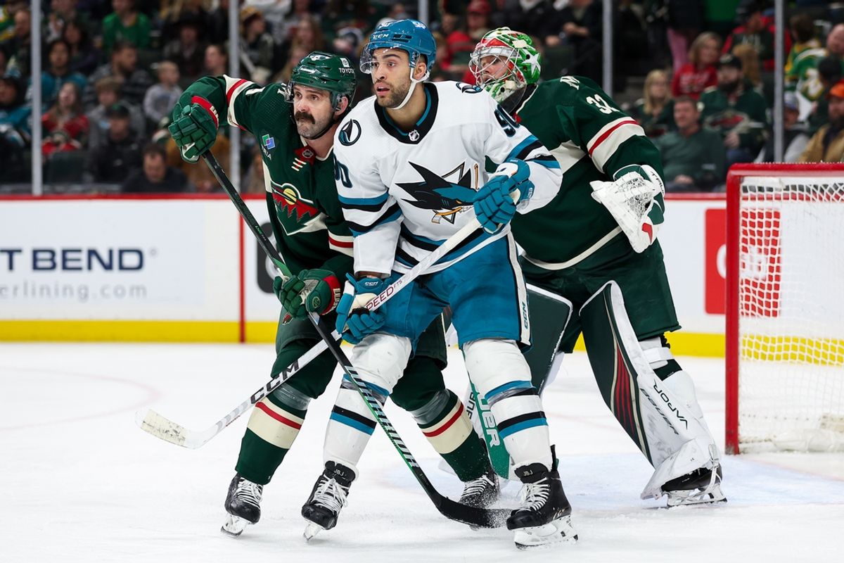 Mar 28, 2024; Saint Paul, Minnesota, USA; Minnesota Wild defenseman Jake Middleton (5) and San Jose Sharks right wing Justin Bailey (90) compete for position as goaltender Filip Gustavsson (32) looks on during the third period at Xcel Energy Center. Mandatory Credit: Matt Krohn-Imagn Images