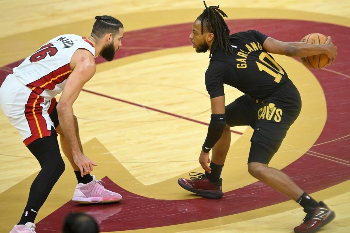 Mar 20, 2024; Cleveland, Ohio, USA; Cleveland Cavaliers guard Darius Garland (10) dribbles beside Miami Heat forward Caleb Martin (16) in the fourth quarter at Rocket Mortgage FieldHouse.