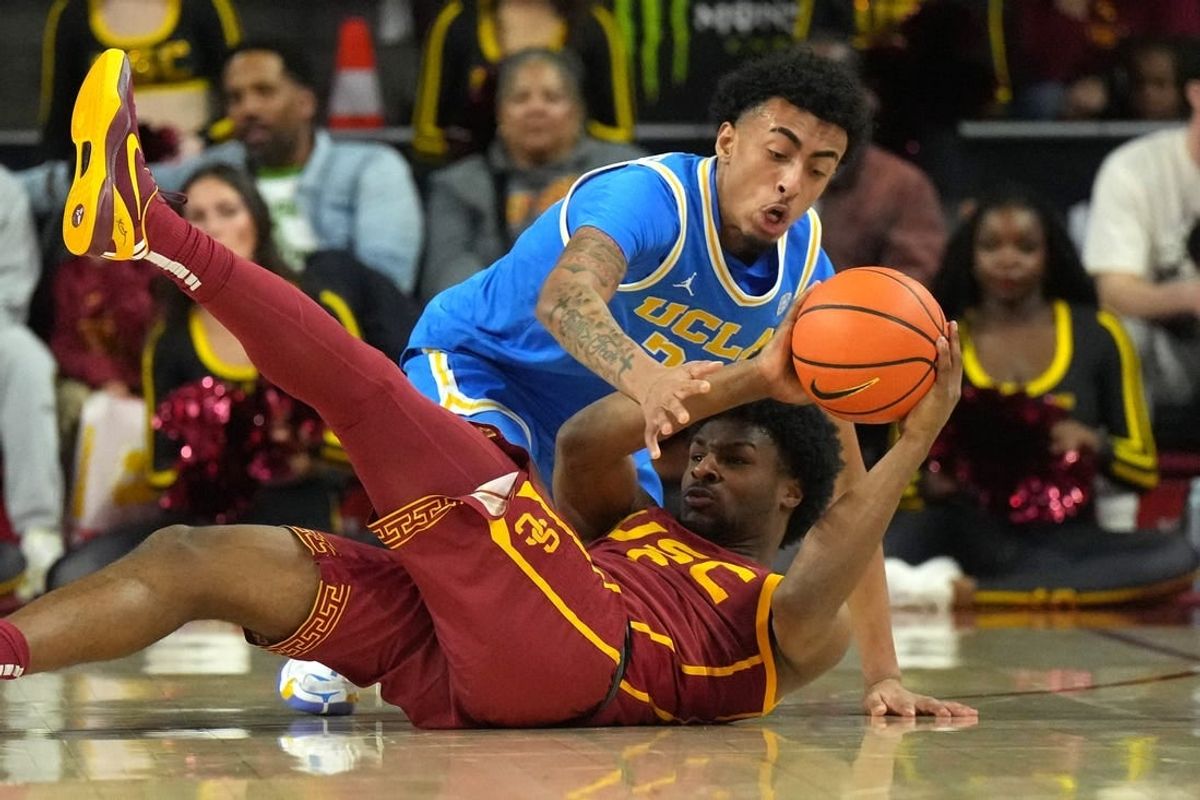 Jan 27, 2024; Los Angeles, California, USA; Southern California Trojans guard Bronny James (6) and UCLA Bruins forward Devin Williams (22) battle for the ball in the first half at Galen Center.