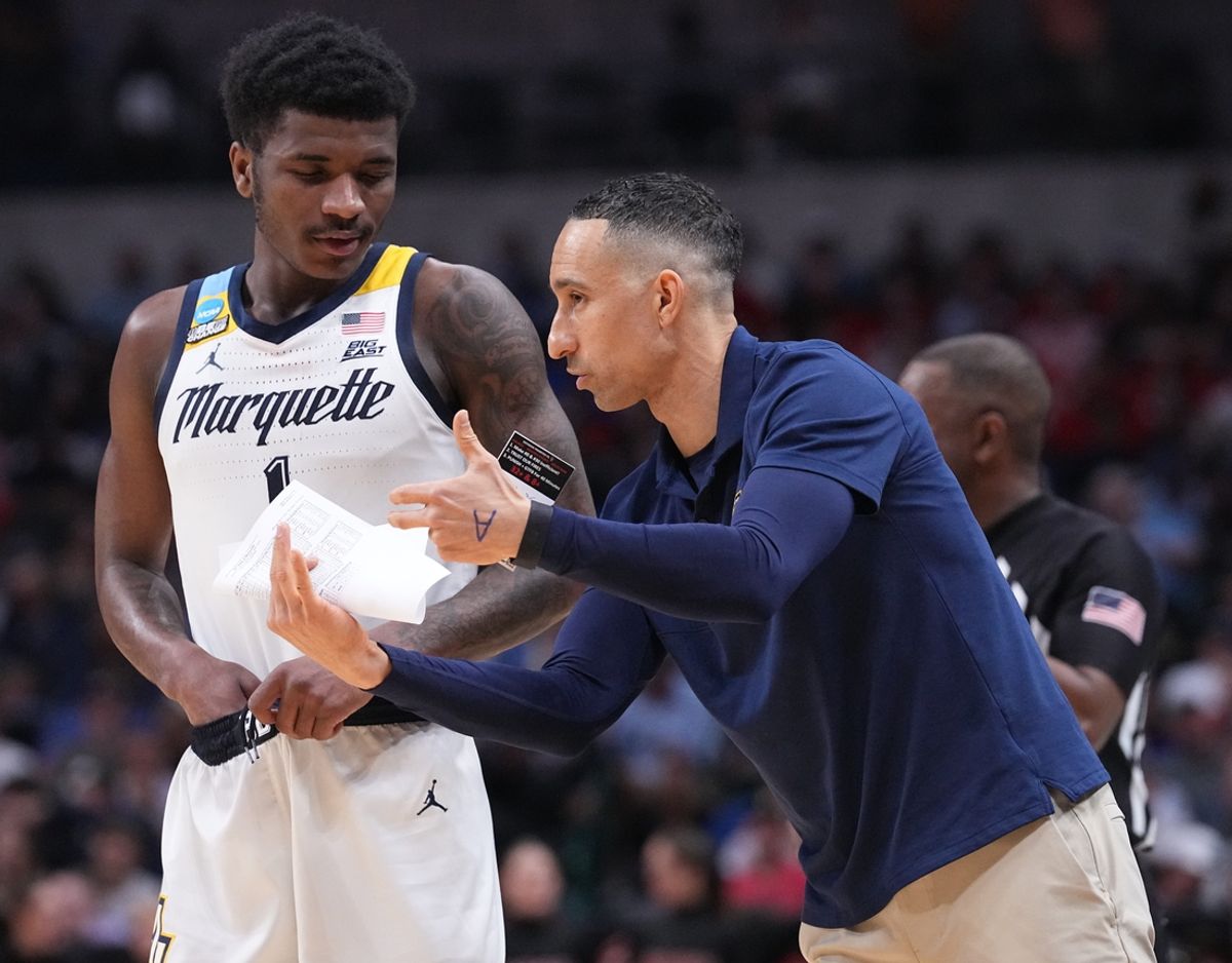 Marquette guard Kam Jones (1) listens to head coach Shaka Smart during the second half of their game in the semifinals of the South Regional of the 2024 NCAA Men's Basketball Tournament Friday at American Airlines Arena in Dallas. North Carolina State beat Marquette 67-58.