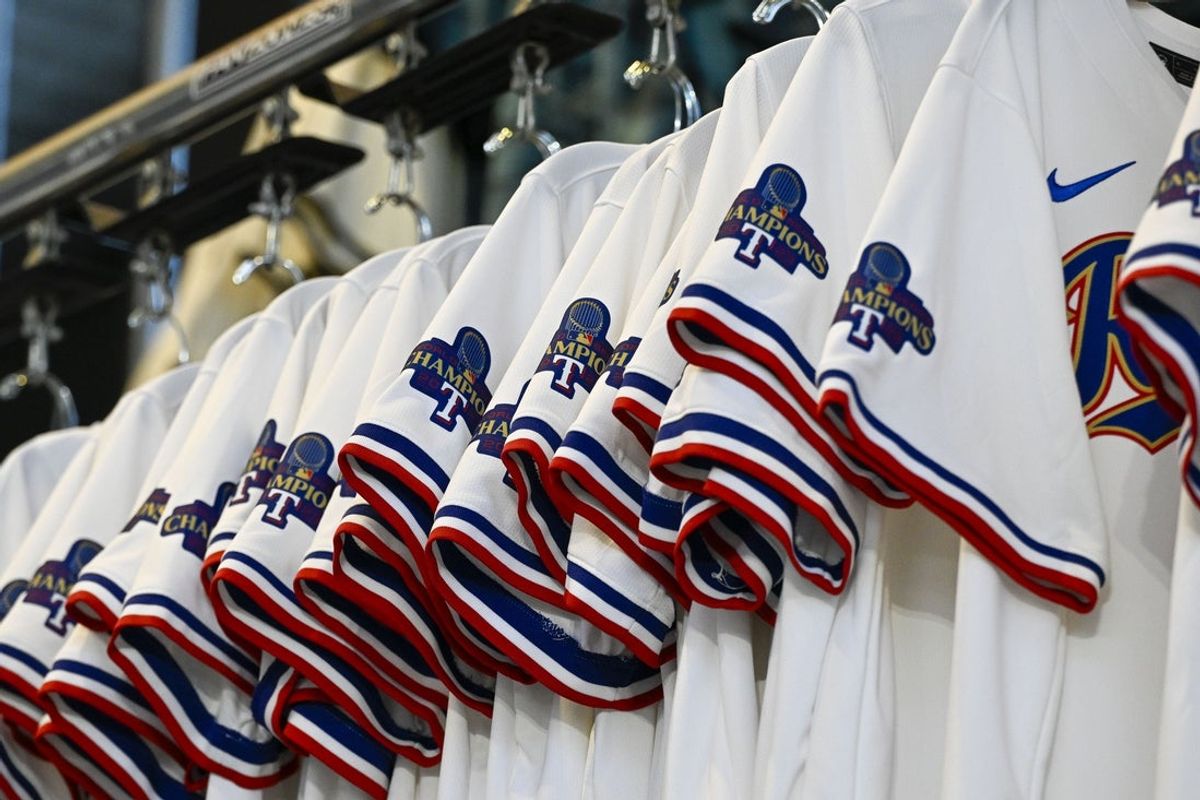 Mar 28, 2024; Arlington, Texas, USA; A view of the Texas Rangers jerseys with World Series Champions patches for sale before the game between the Texas Rangers and the Chicago Cubs at Globe Life Field. Mandatory Credit: Jerome Miron-Imagn Images