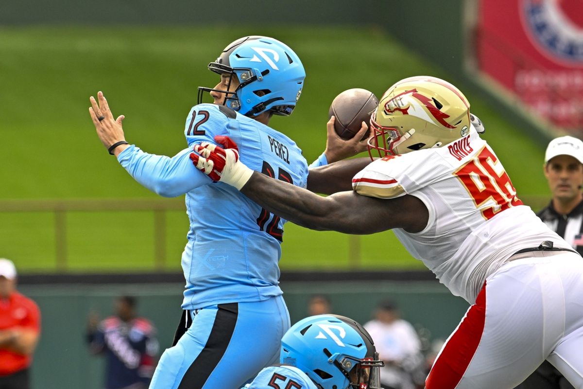Mar 30, 2024; Arlington, TX, USA; Birmingham Stallions defensive lineman Carlos Davis (96) forces a fumble by Arlington Renegades quarterback Luis Perez (12) during the first half at Choctaw Stadium. Mandatory Credit: Jerome Miron-USA TODAY Sports