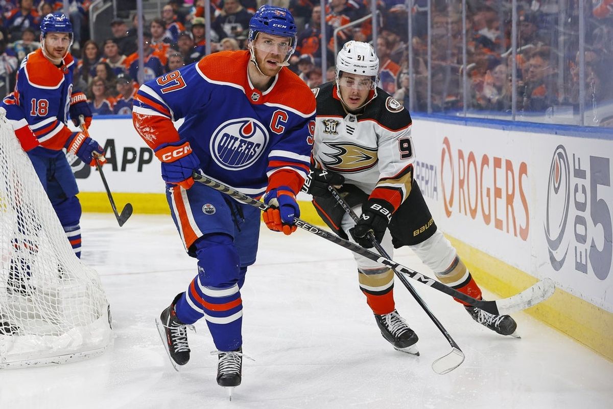 Mar 30, 2024; Edmonton, Alberta, CAN; Edmonton Oilers forward Connor McDavid (97) and forward Leo Carlsson (91) look for a loose puck during the third period at Rogers Place. Mandatory Credit: Perry Nelson-Imagn Images
