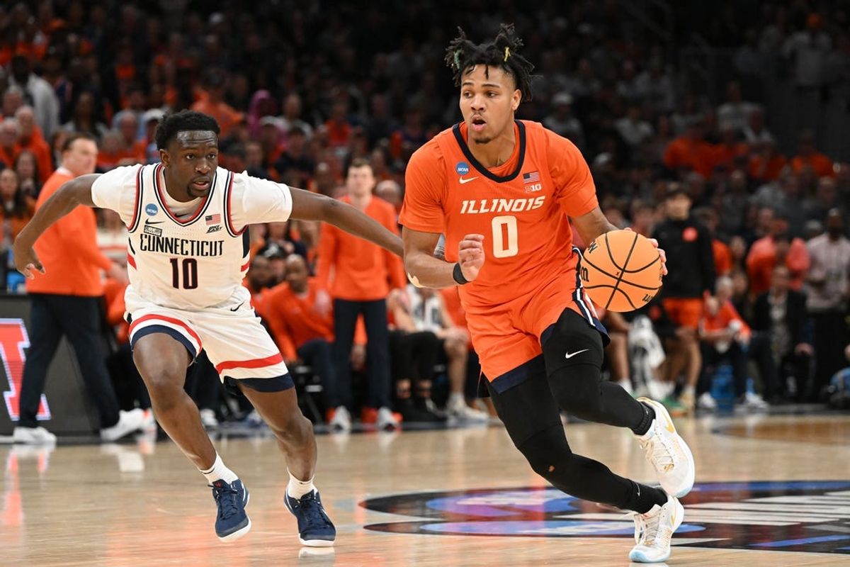 Mar 30, 2024; Boston, MA, USA; Illinois Fighting Illini guard Terrence Shannon Jr. (0) dribbles the ball against Connecticut Huskies guard Hassan Diarra (10) in the finals of the East Regional of the 2024 NCAA Tournament at TD Garden. Mandatory Credit: Brian Fluharty-USA TODAY Sports