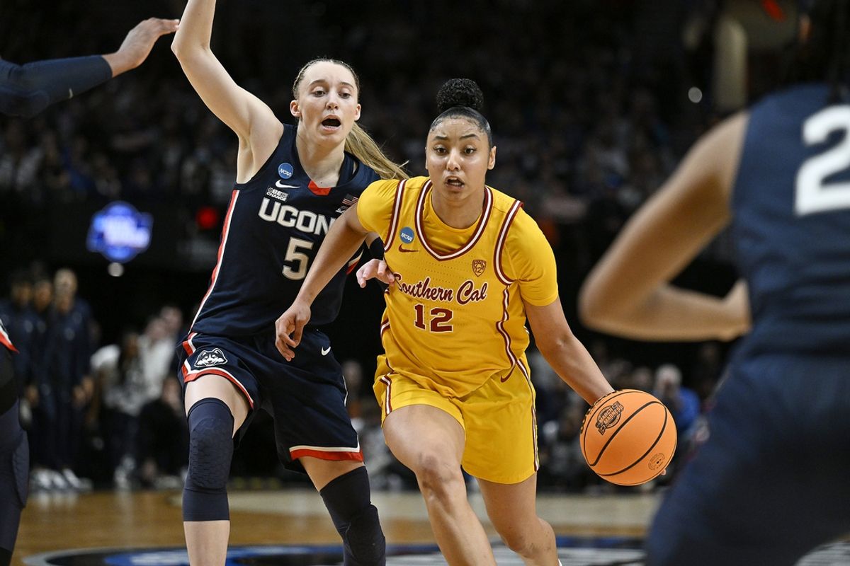 Apr 1, 2024; Portland, OR, USA; USC Trojans guard JuJu Watkins (12) drives to the basket during the second half against UConn Huskies guard Paige Bueckers (5) in the finals of the Portland Regional of the NCAA Tournament at the Moda Center. Mandatory Credit: Troy Wayrynen-Imagn Images